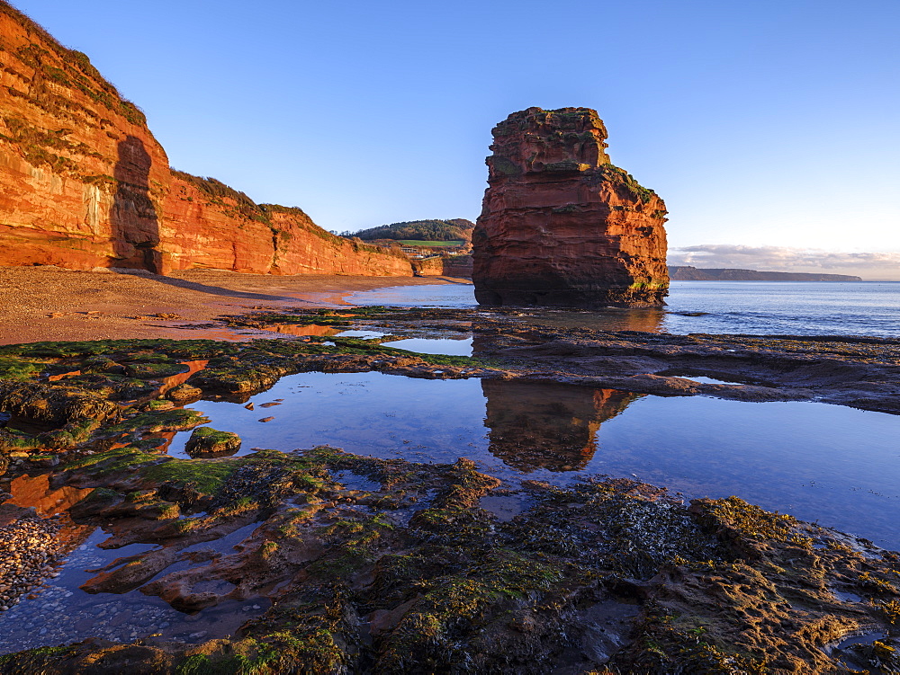 Dawn on the beach with one of the majestic sea stacks at Ladram Bay, Sidmouth, Devon, England, United Kingdom, Europe