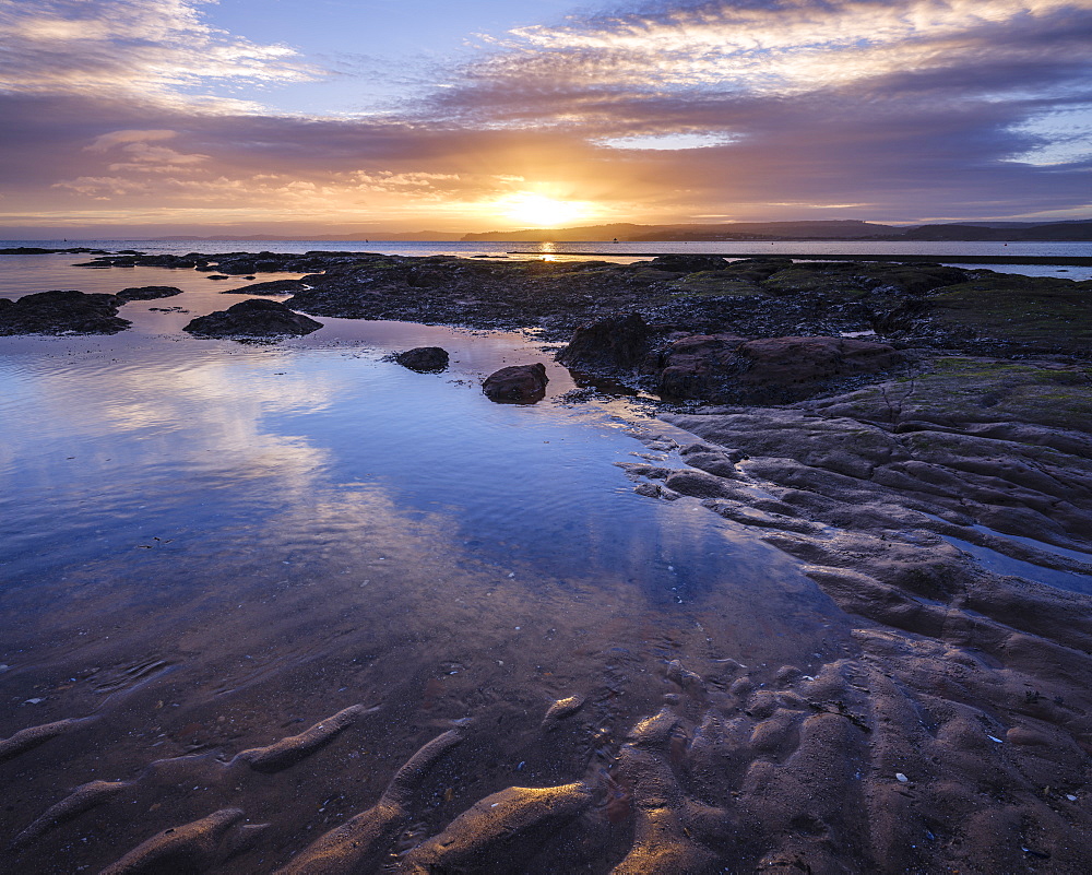 Winter sunset viewed from Maer Rocks, near Orcombe Point, Exmouth, Devon, England, United Kingdom, Europe