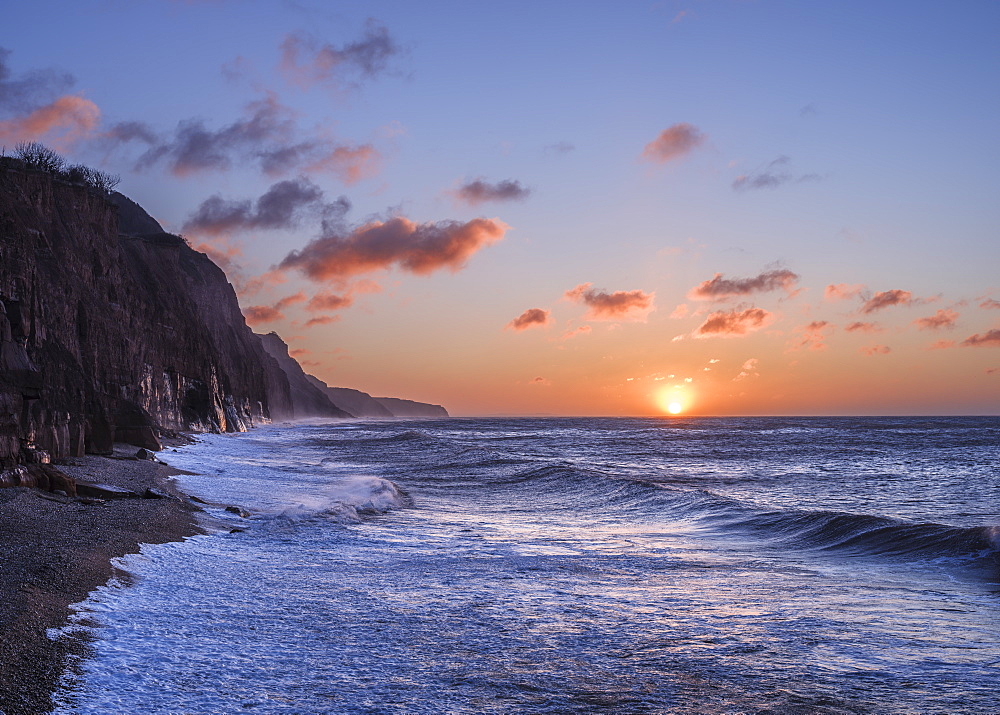 Stormy seas at sunrise at the cliffs in the seaside town of Sidmouth, Devon, England, United Kingdom, Europe