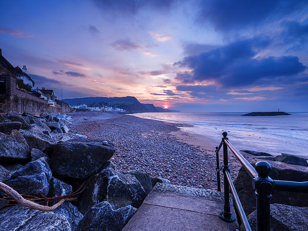 Sunrise looking along the beach at the picturesque seaside town of Sidmouth, Devon, England, United Kingdom, Europe