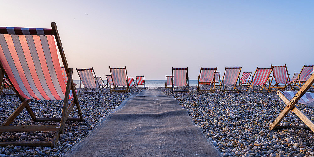 Deckchairs on the popular pebble beach at Beer near Seaton, Devon, England, United Kingdom, Europe