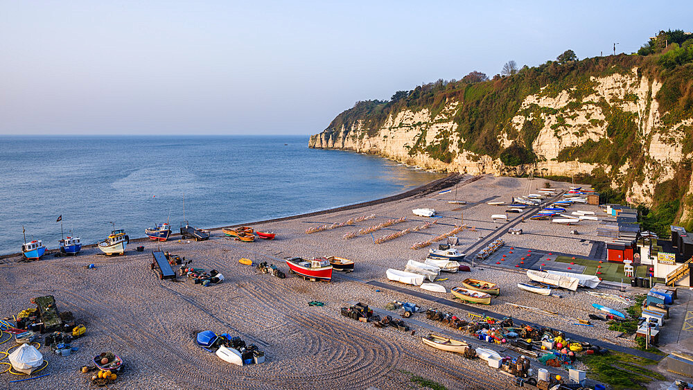 Fishing boats and deckchairs on the popular pebbled beach at Beer near Seaton, Devon, England, United Kingdom, Europe