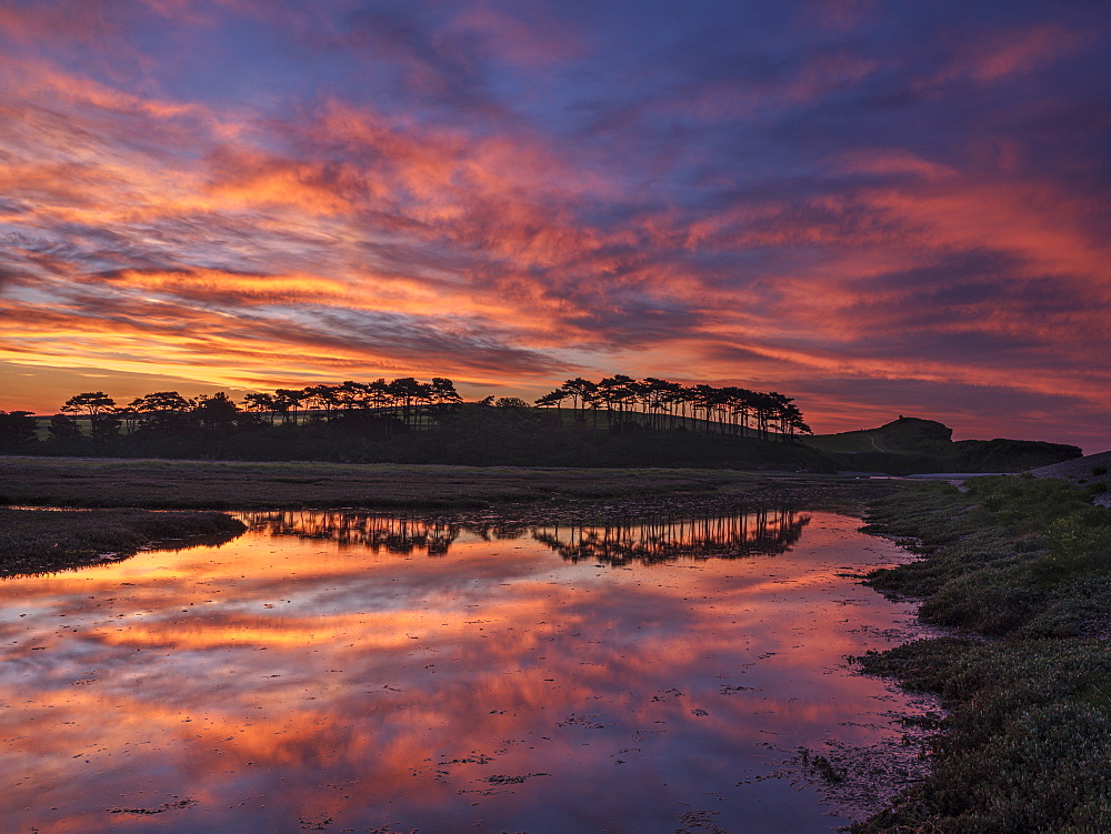 Twilight clouds with intense dawn colour and perfect reflections on the River Otter at Budleigh Salterton, Devon, England, United Kingdom, Europe