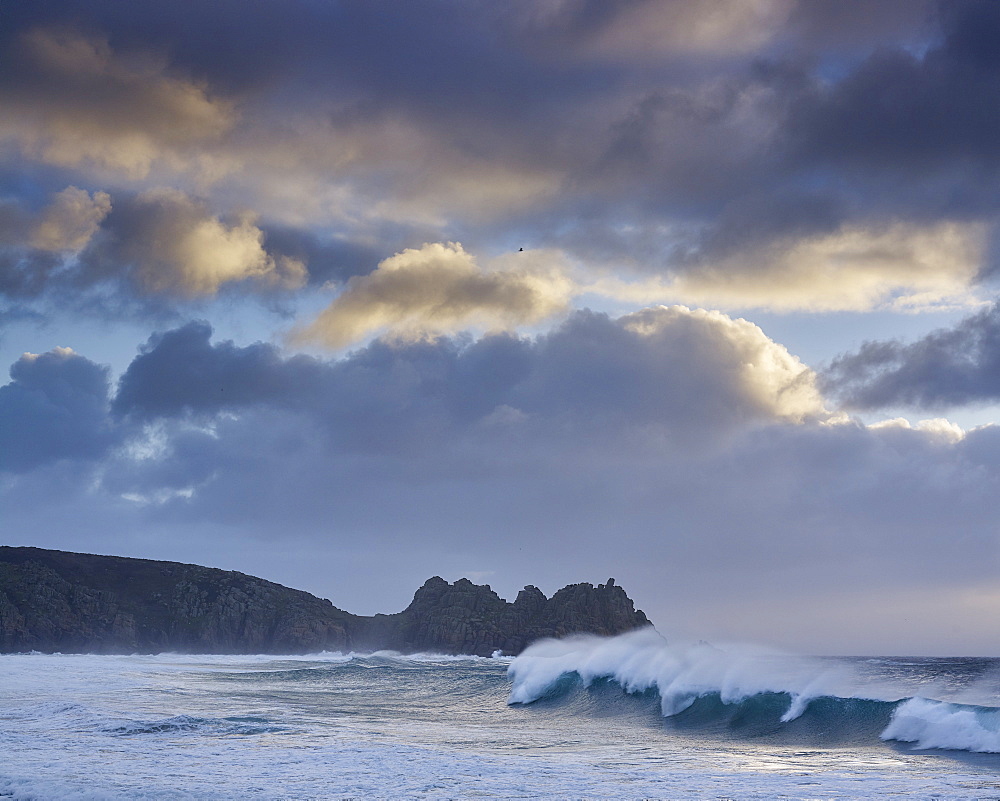 Huge surf looking out towards Logan Rock at Porthcurno, Cornwall, England, United Kingdom, Europe