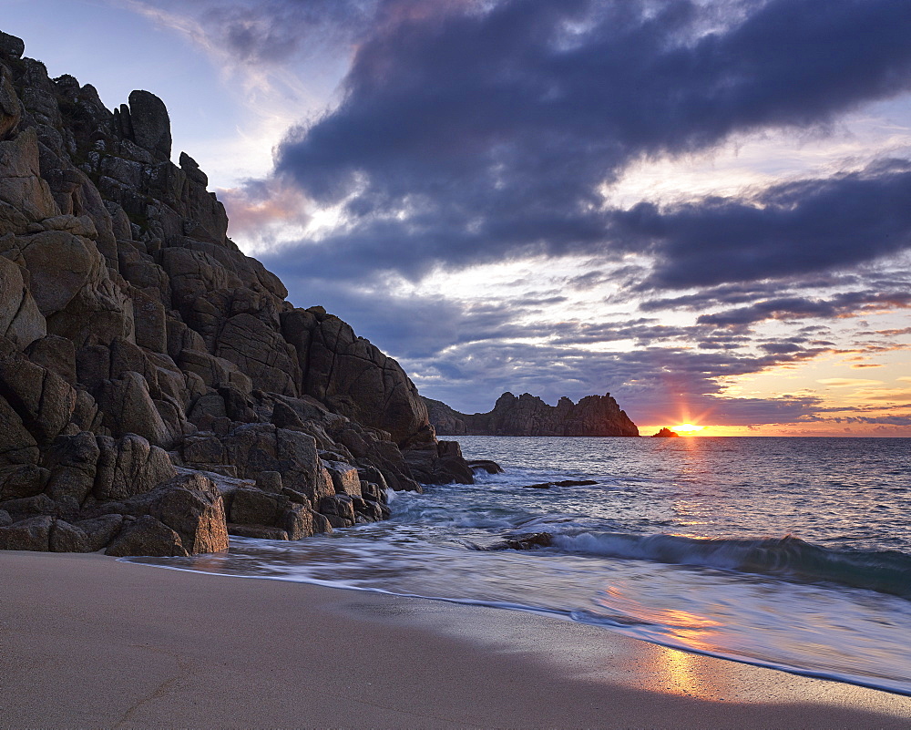 Early morning on the beach looking out towards Logan Rock at Porthcurno, Cornwall, England, United Kingdom, Europe