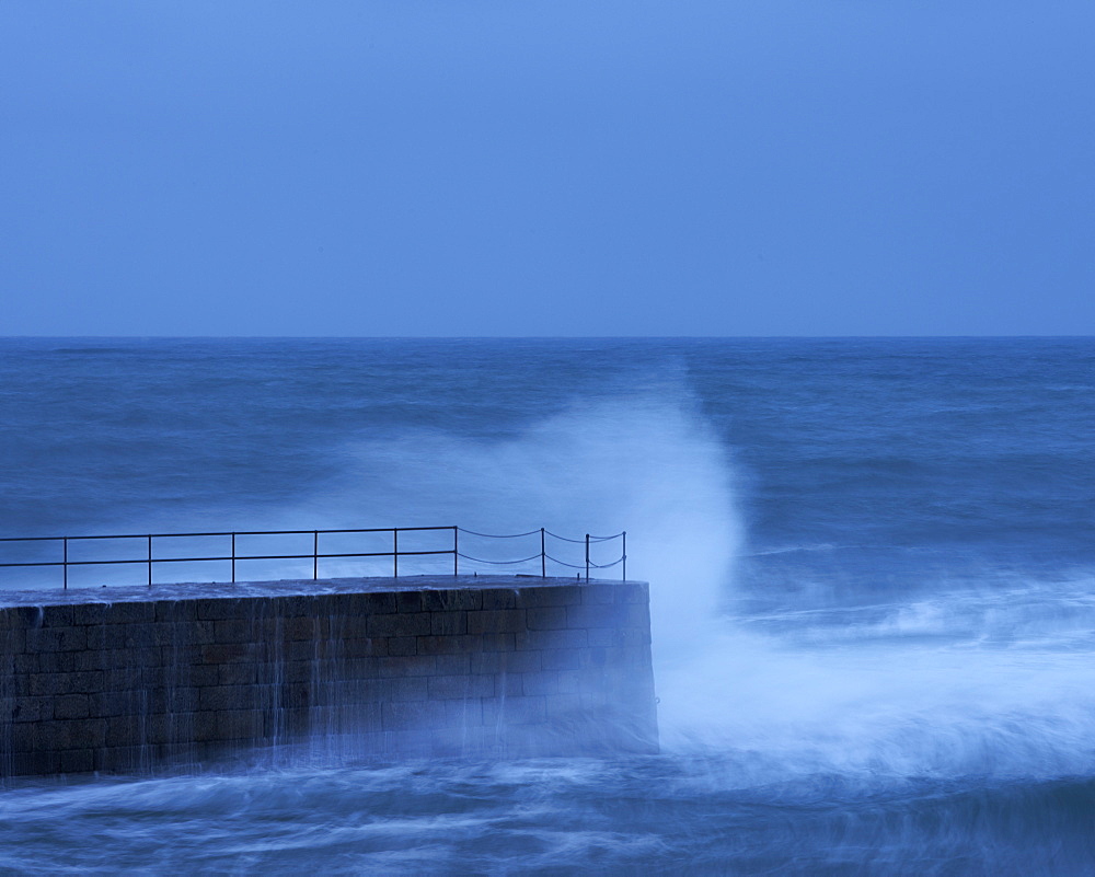 Wave in a storm strikes the breakwater at Porthleven in Cornwall, England, United Kingdom, Europe