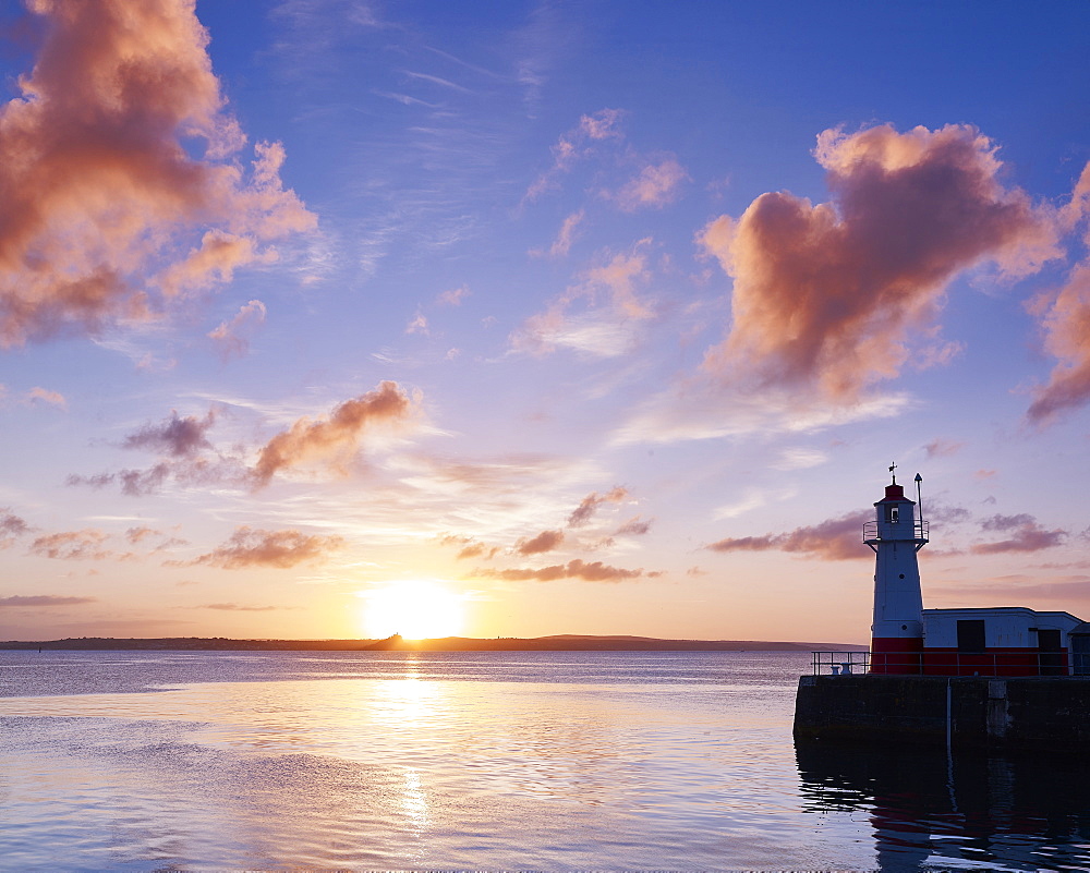 Summer sunrise on the harbour wall at the fishing port of Newlyn, Cornwall, England, United Kingdom, Europe