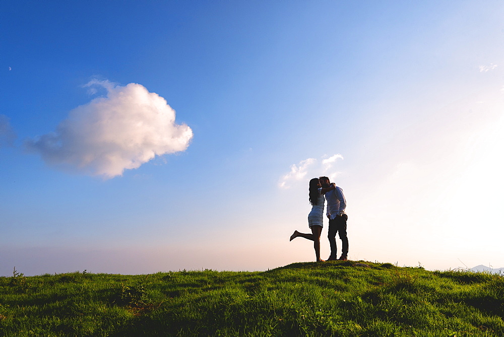 Couple in love just before sunset on Mount Guglielmo, Brescia pre-Alps, Brescia Province, Lombardy, Italy, Europe