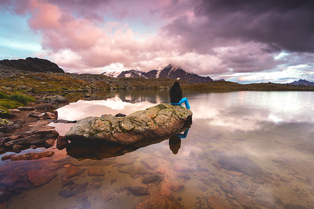 Girl by the Manzina lake at sunset, Valfurva, Valtellina, Lombardy, Italy, Europe