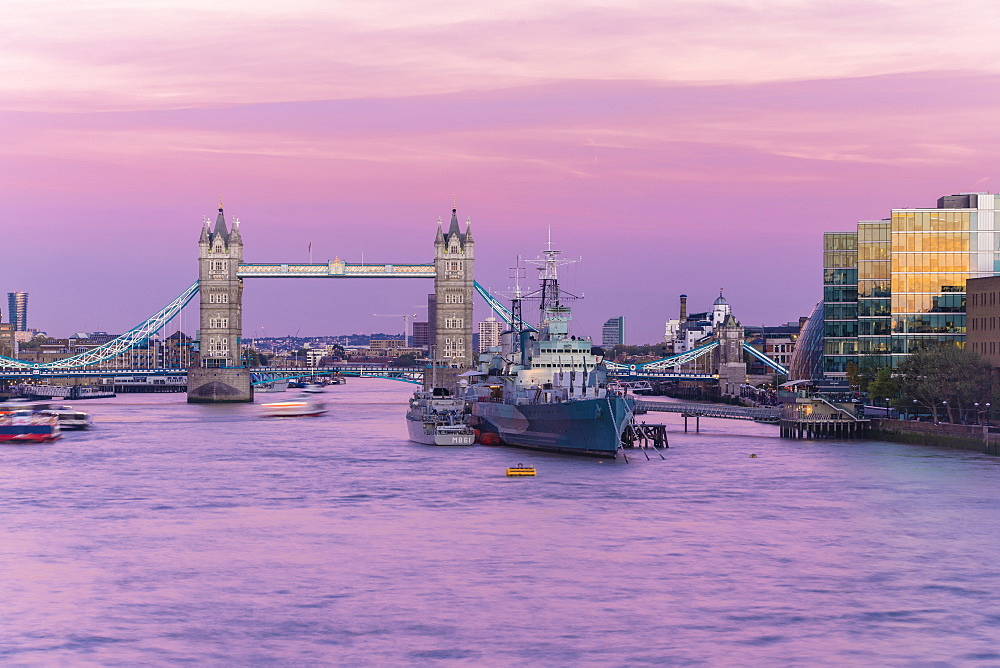 Tower Bridge with HMS Belfast at sunset with purple sky above the River Thames, London, England, United Kingdom, Europe