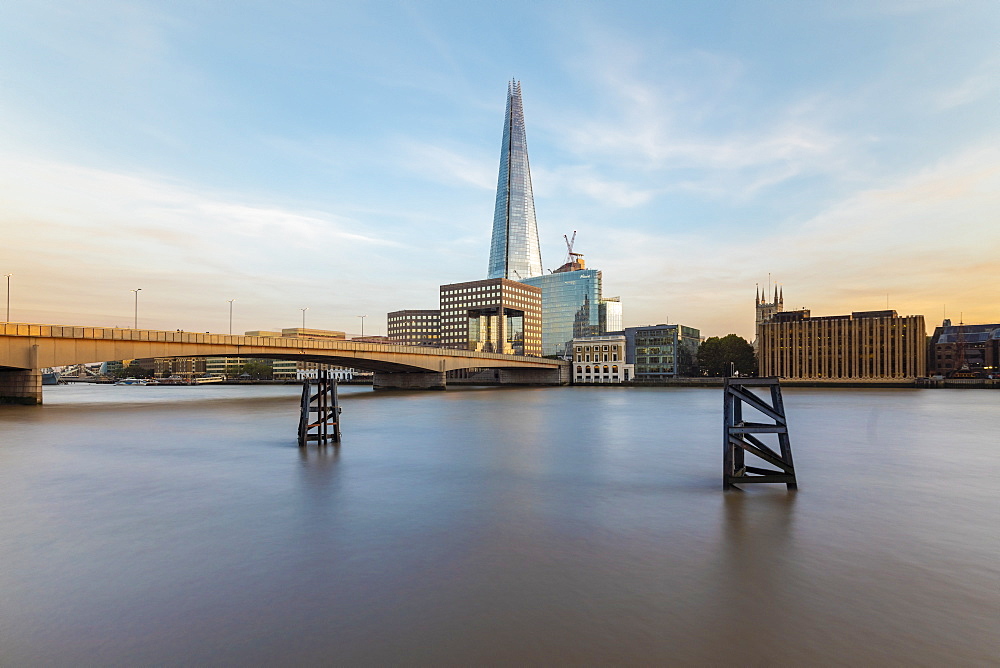 Long exposure of the River Thames with London Bridge and The Shard in the background by sunset, London, England, United Kingdom, Europe