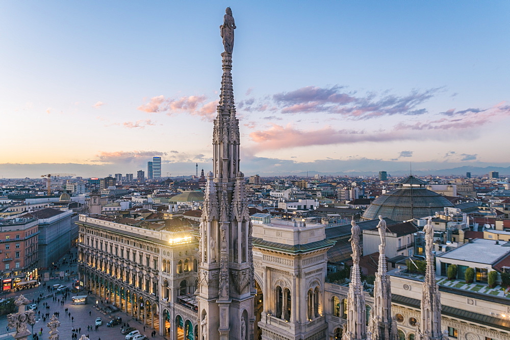 View of the statues on the Cathedral of Milan and the skyline of Milan seen in the background, Milan, Lombardy, Italy, Europe