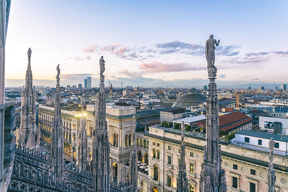 View of the statues on the Cathedral of Milan and the skyline of Milan seen in the background, Milan, Lombardy, Italy, Europe