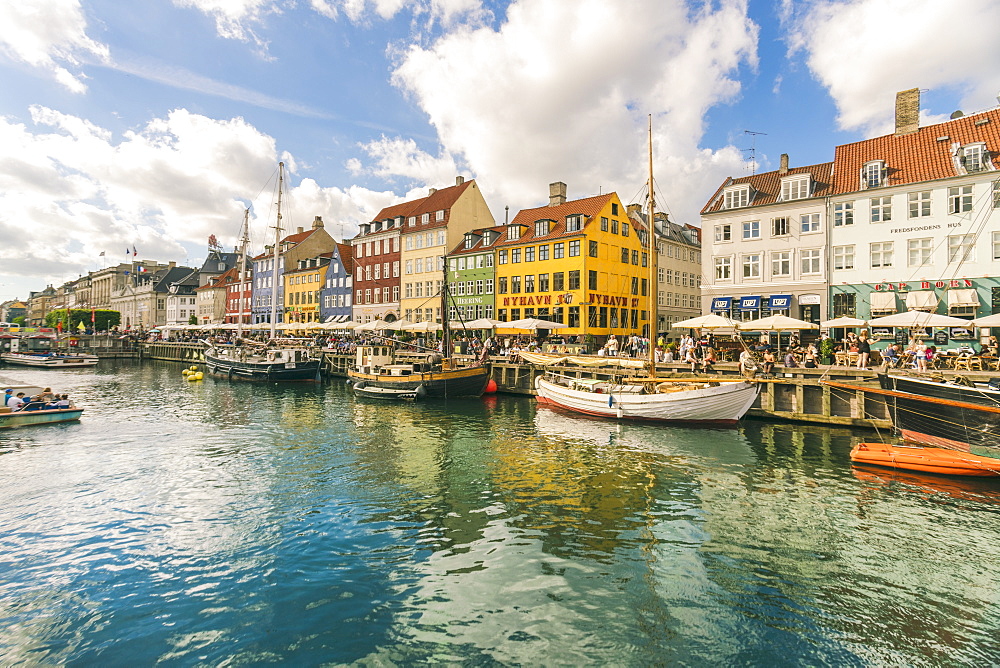 Nyhavn with old colourful houses and boats anchored in summer, Copenhagen, Denmark, Europe