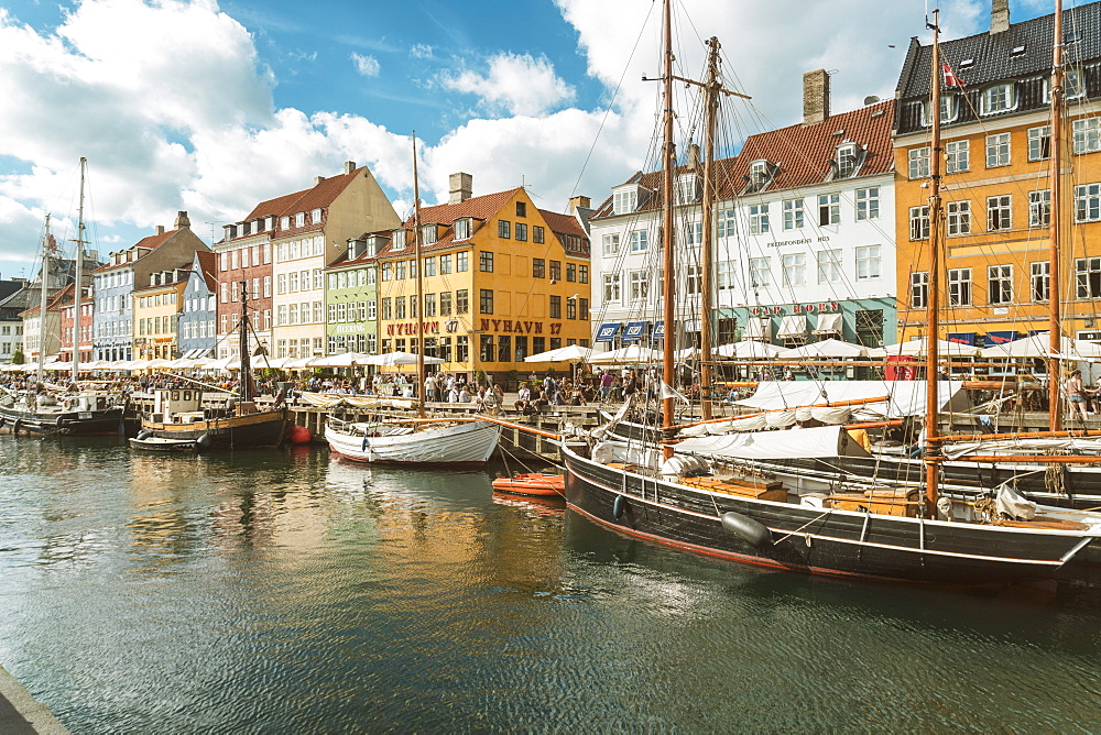 Nyhavn with old colourful houses and boats anchored in summer, Copenhagen, Denmark, Europe