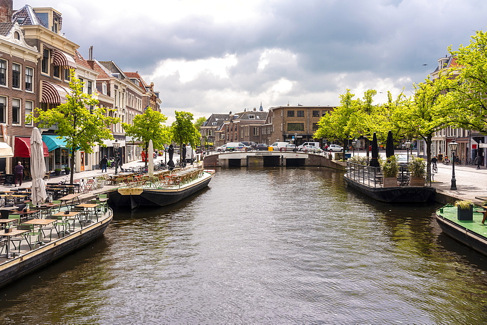 Nieuwe Rijn (New Rhine) canal with Karnemelksbrug bridge, cafes and shops in the heart of Leiden, South Holland, The Netherlands, Europe