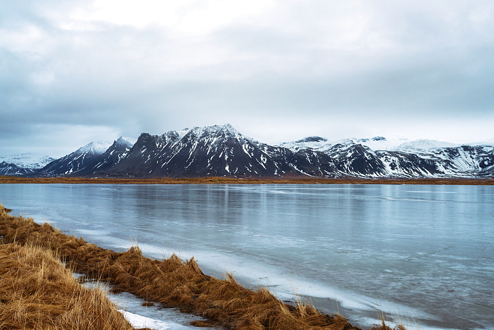 View of the mountains of Snaefellsnes at the peninsula early in the morning with water freezing in the foreground, Iceland, Polar Regions