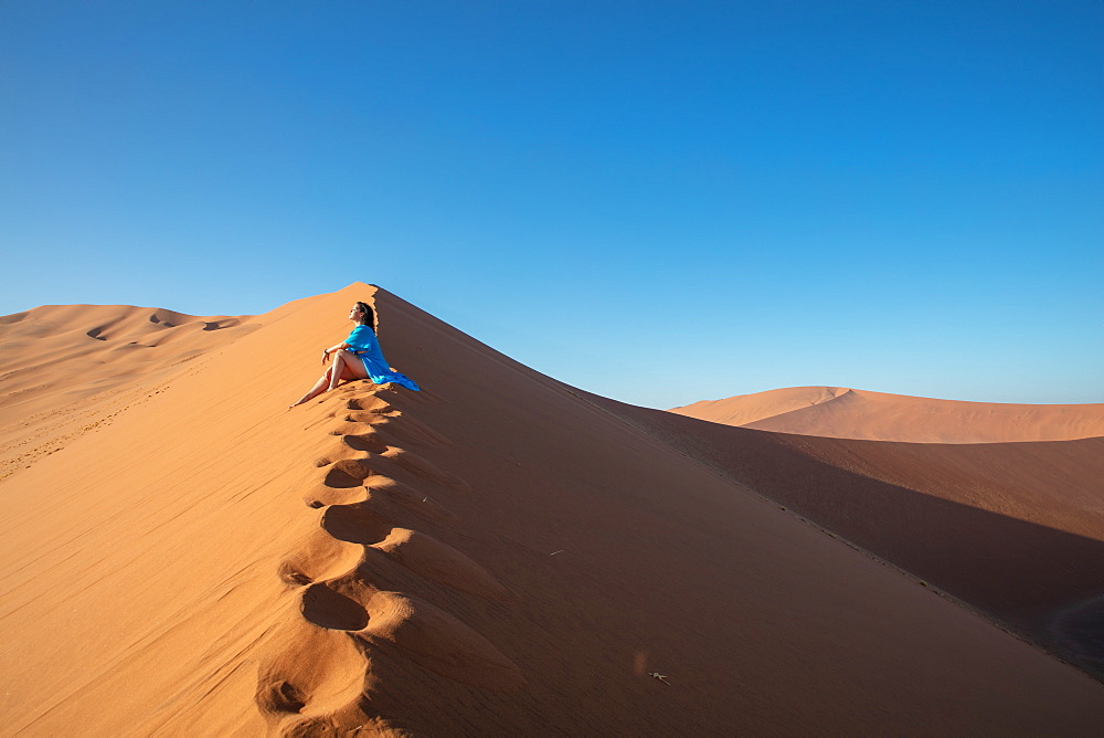 Model climbing Dune 13, Sossusvlei, Namibia, Africa