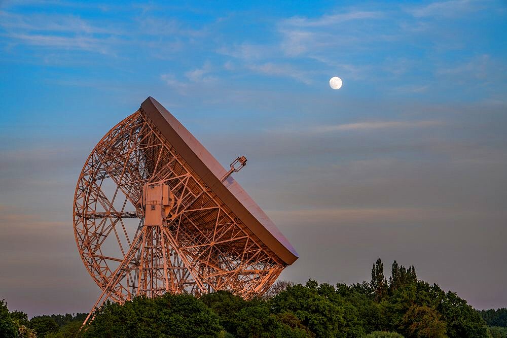 The Lovell Mark I Giant Radio Telescope with perfect alignment with the full moon, Jodrell Bank, Cheshire, England