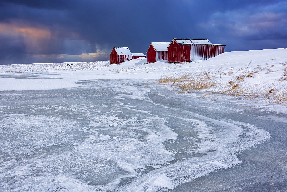 Dramatic sky over typical fishermen houses called Rorbu in winter, Eggum, Lofoten Islands, Arctic, Norway, Europe