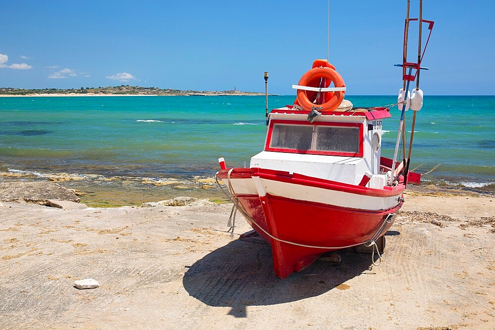 Colourful fishing boat on slipway, the turquoise waters of the Mediterranean Sea beyond, Sampieri, Ragusa, Sicily, Italy, Europe