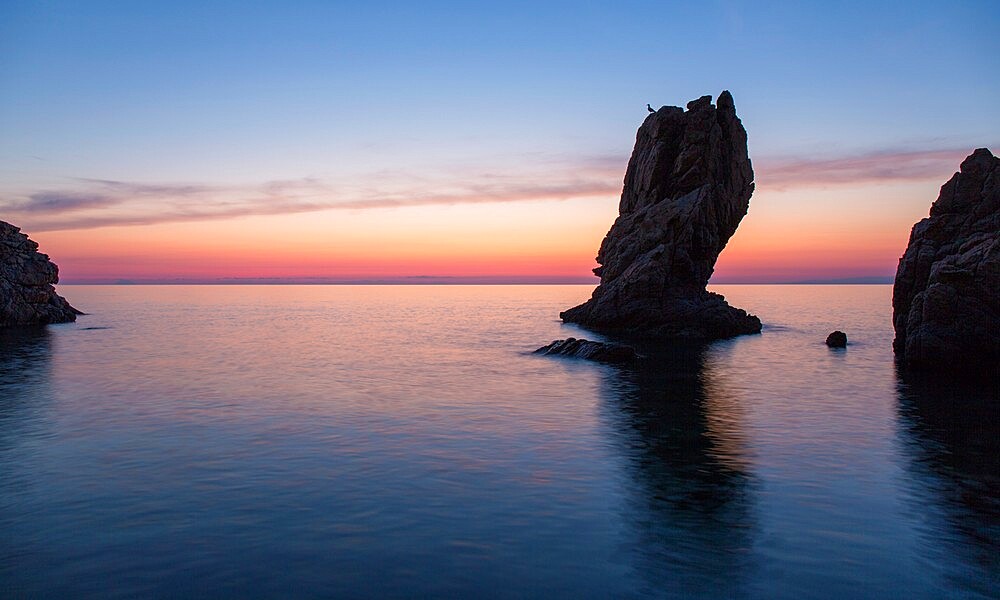 View from Calura Bay across the Tyrrhenian Sea, dawn, rock stack silhouetted against red sky, Cefalu, Palermo, Sicily, Italy, Mediterranean, Europe