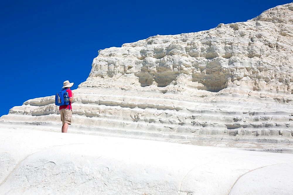 Visitor admiring the white limestone cliffs of the Scala dei Turchi, Realmonte, Porto Empedocle, Agrigento, Sicily, Italy, Mediterranean, Europe