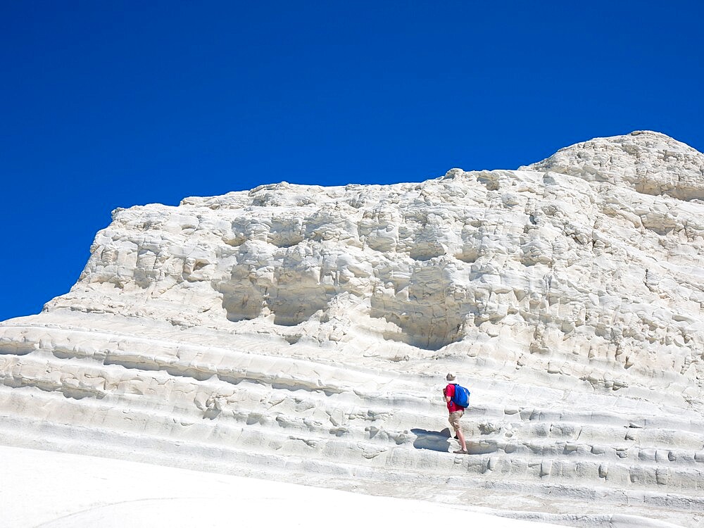 Visitor ascending the white limestone cliffs of the Scala dei Turchi, Realmonte, Porto Empedocle, Agrigento, Sicily, Italy, Mediterranean, Europe