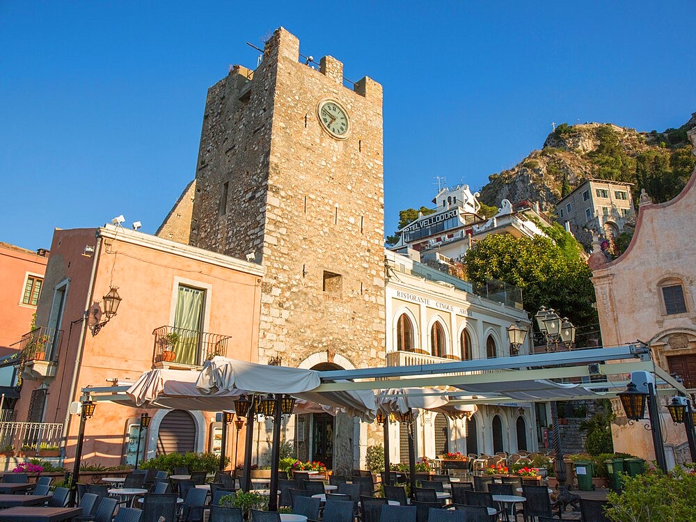 View from Piazza IX Aprile to the 12th century clock tower, Torre dell'Orologio, early morning, Taormina, Messina, Sicily, Italy, Mediterranean, Europe