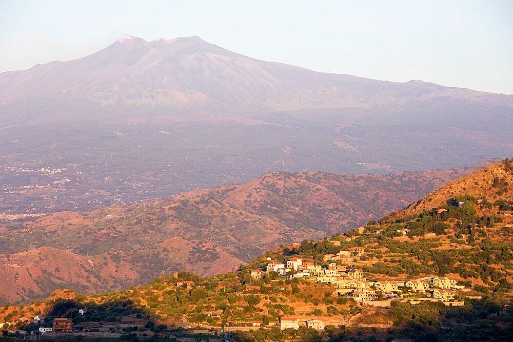 View across rolling volcanic landscape to the summit of Mount Etna, UNESCO World Heritage Site, at sunrise, Taormina, Messina, Sicily, Italy, Mediterranean, Europe