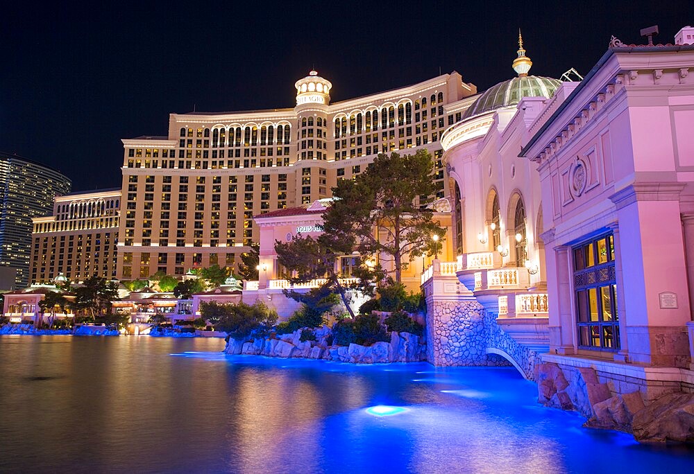 View by night across colourful lake to the illuminated facade of the Bellagio Hotel and Casino, Las Vegas, Nevada, United States of America, North America