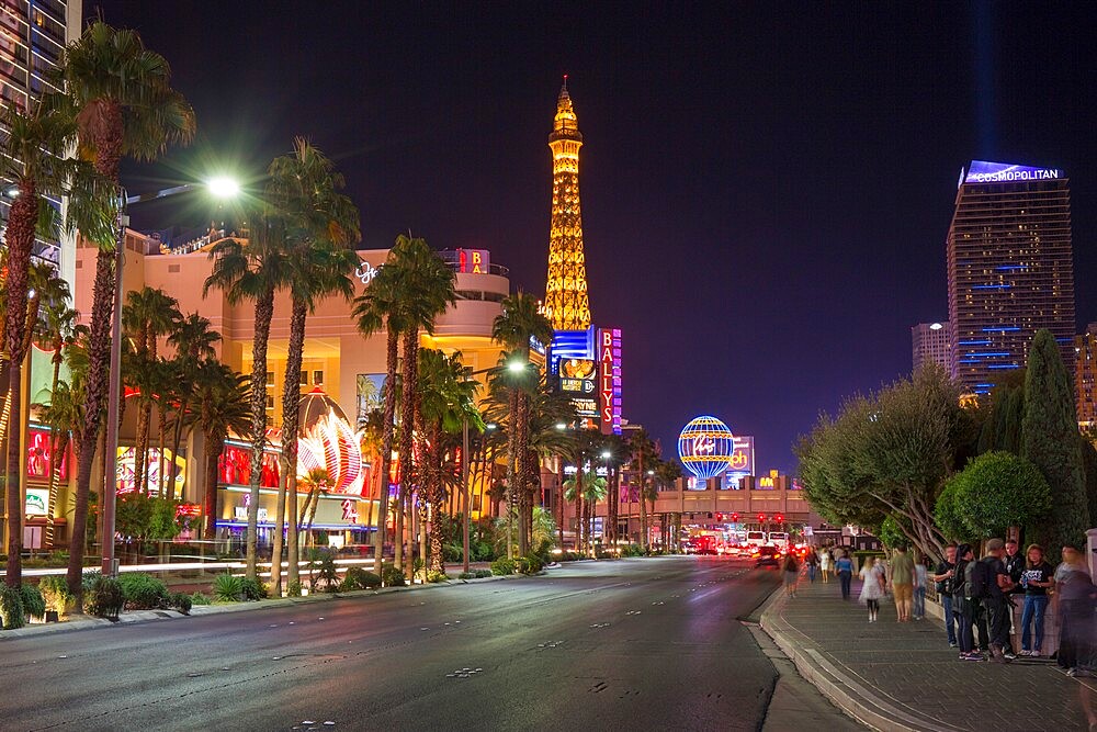 View along The Strip by night, illuminated Eiffel Tower at the Paris Hotel and Casino prominent, Las Vegas, Nevada, United States of America, North America