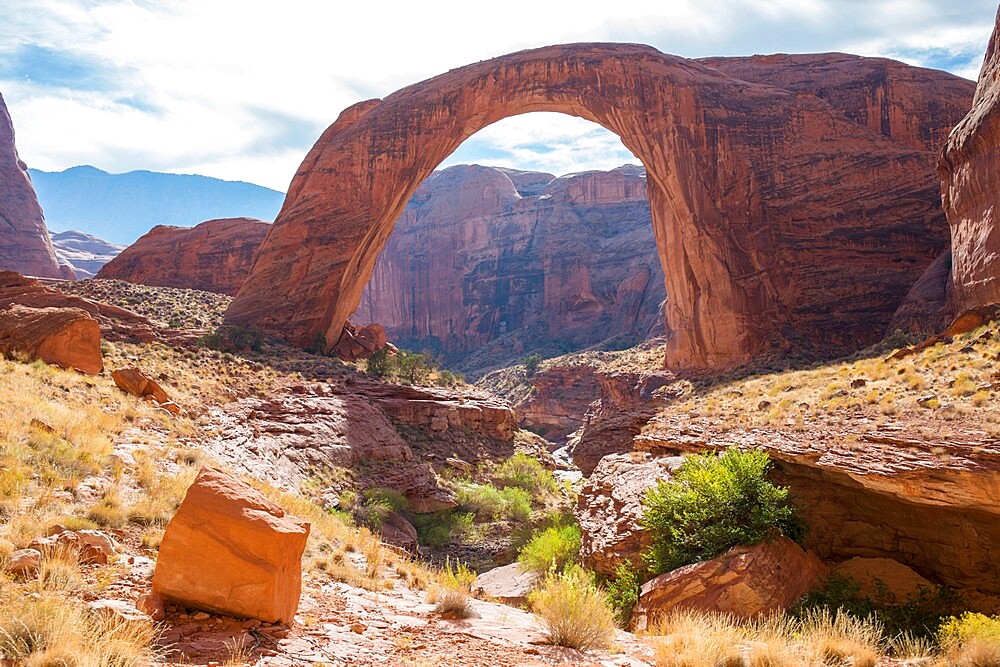 View across rocky landscape to Rainbow Bridge National Monument, Glen Canyon National Recreation Area, Utah, United States of America, North America