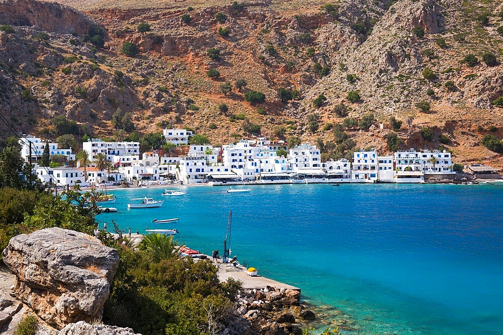 View across the tranquil waters of the harbour, Loutro, Hania (Chania), Crete, Greek Islands, Greece, Europe