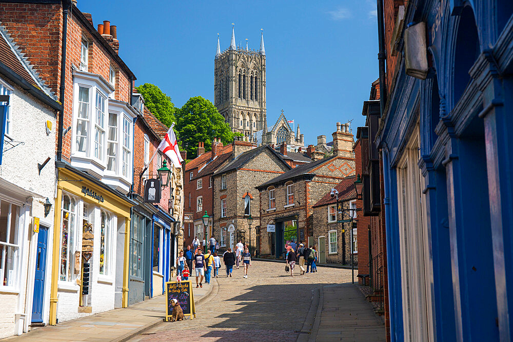 View up The Strait to Steep Hill and the central tower of Lincoln Cathedral, Lincoln, Lincolnshire, England, United Kingdom, Europe