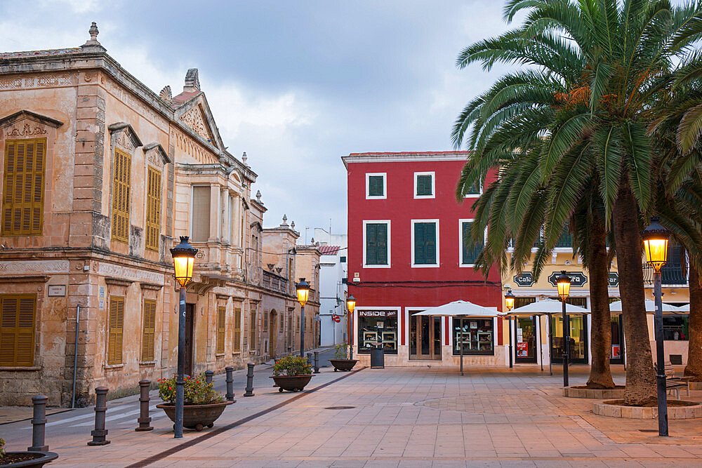 View across illuminated Placa d'Alfons III Conqueridor at dawn, Ciutadella (Ciudadela), Menorca, Balearic Islands, Spain, Mediterranean, Europe