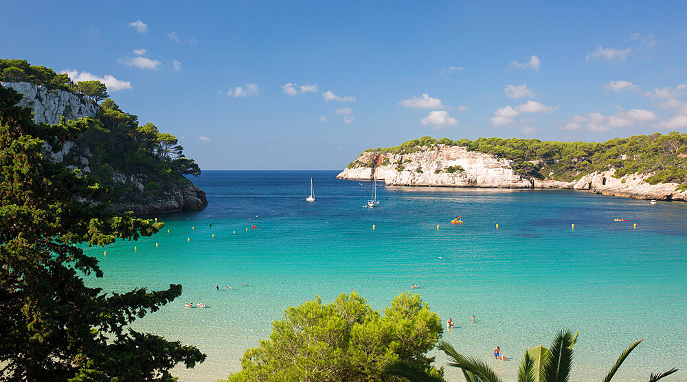 View over the turquoise waters of the Mediterranean Sea to distant white cliffs, Cala Galdana, Menorca, Balearic Islands, Spain, Mediterranean, Europe