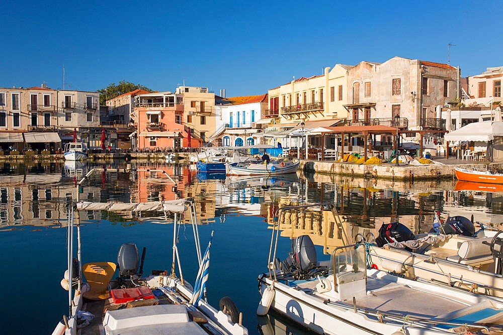 View across the Venetian Harbour, quayside buildings reflected in still water, Rethymno (Rethymnon), Crete, Greek Islands, Greece, Europe