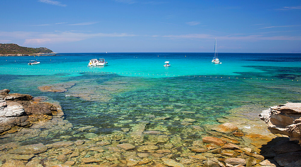 View across clear turquoise water from rocky coastline near the Plage du Loto, St-Florent, Haute-Corse, Corsica, France, Mediterranean, Europe