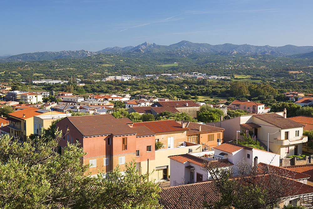 View over tiled rooftops to verdant countryside from hillside above the town, Arzachena, Sassari, Sardinia, Italy, Mediterranean, Europe