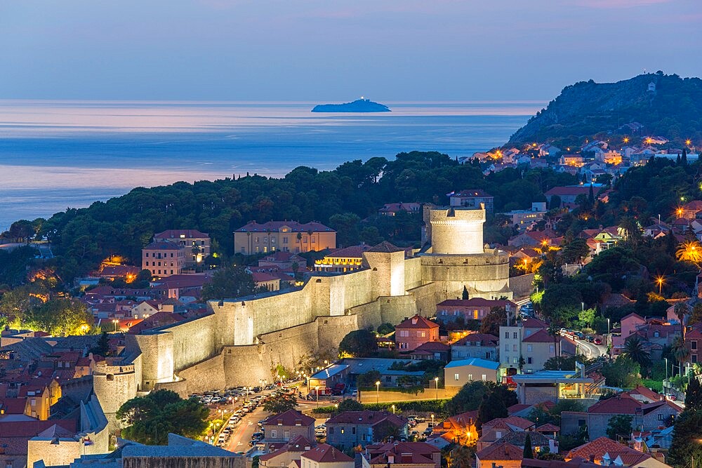 View over the illuminated city walls from above, dusk, the Adriatic Sea beyond, Dubrovnik, UNESCO World Heritage Site, Dubrovnik-Neretva, Dalmatia, Croatia, Europe