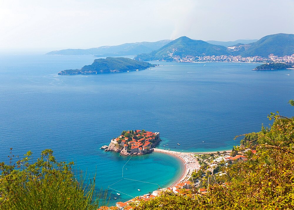 High angle view from hillside over Budva Bay and the exclusive island resort of Sveti Stefan, Budva, Montenegro, Europe