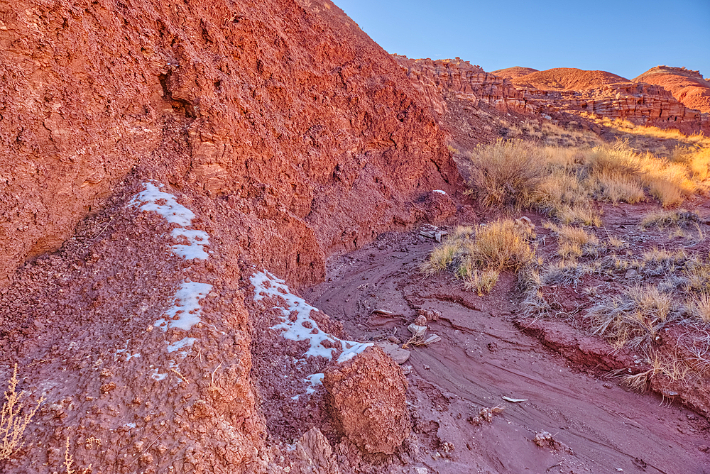 Patches of snow in the shade of a hill in Dead Wash at Petrified Forest National Park Arizona.