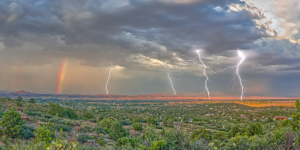 A lightning storm with a rainbow rolling over Mingus Mountain just east of Chino Valley, Arizona, United States of America, North America