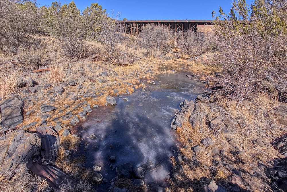 View from below the historic Bainbridge Steel Dam near Ash Fork Arizona in the Kaibab National Forest. It was originally constructed in the late 1800s and is now a historic landmark that is open to the public.