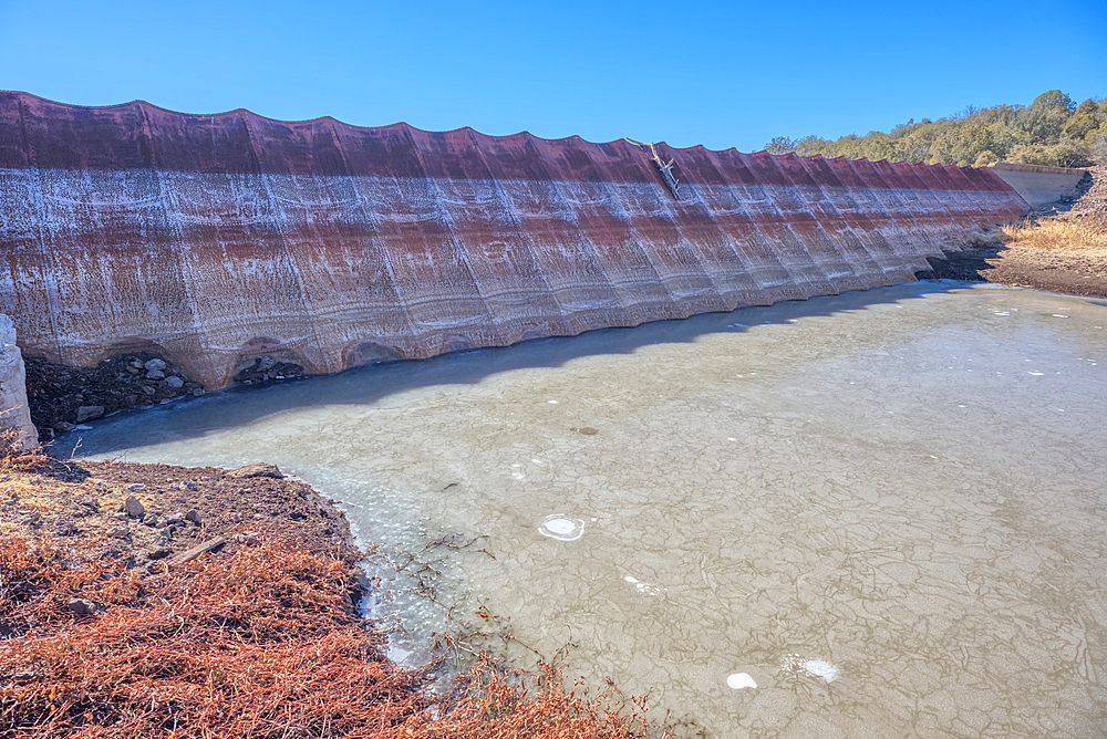 Top face view of the historic Bainbridge Steel Dam near Ash Fork Arizona in the Kaibab National Forest. It was originally constructed in the late 1800s and is now a historic landmark that is open to the public.