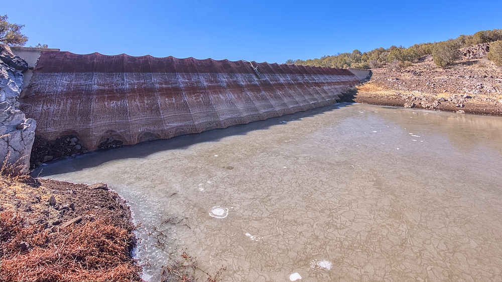Top face view of the historic Bainbridge Steel Dam near Ash Fork Arizona in the Kaibab National Forest. It was originally constructed in the late 1800s and is now a historic landmark that is open to the public.