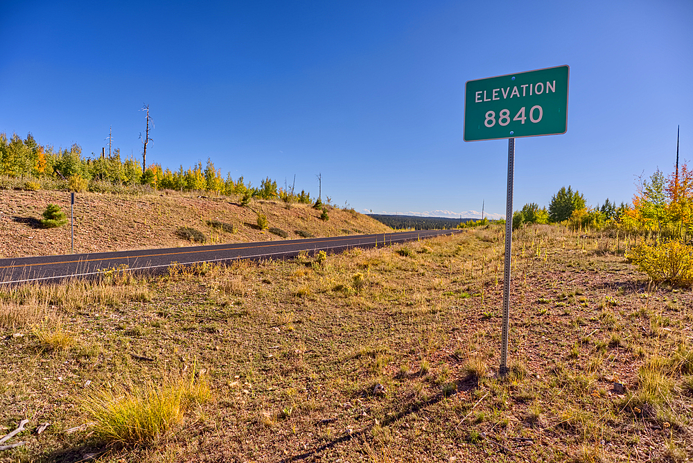 A sign marking 8840 foot elevation on the Kaibab Plateau in northern Arizona. This is the highest point on the plateau.