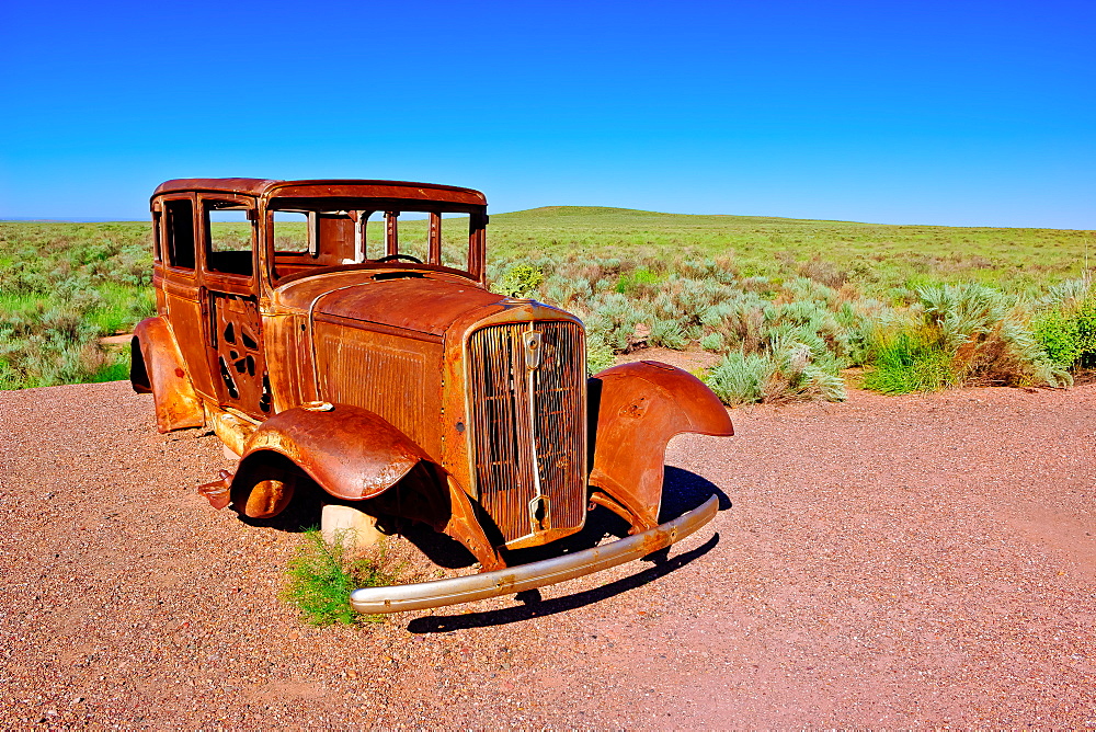 The old rusting steel shell of a Model-T mounted on concrete pillars along the old historic Route 66, Arizona, United States of America, North America