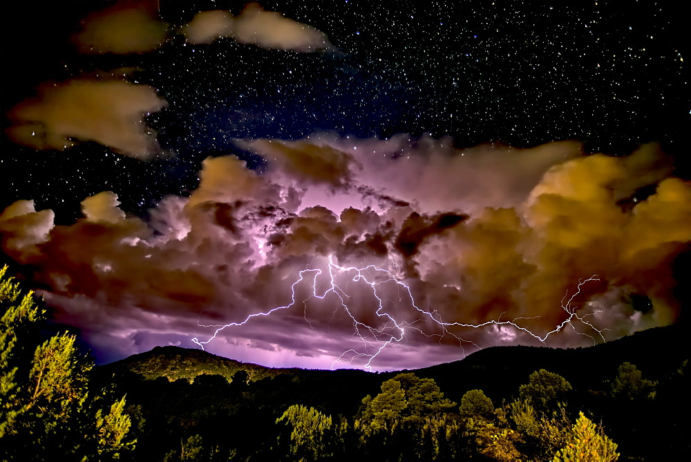 A storm approaching Sullivan Butte in Chino Valley at night with a starry sky above, Arizona, United States of America, North America